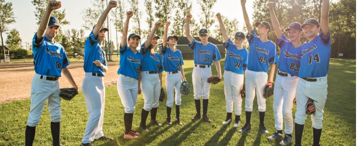 A baseball team celebrates after a game